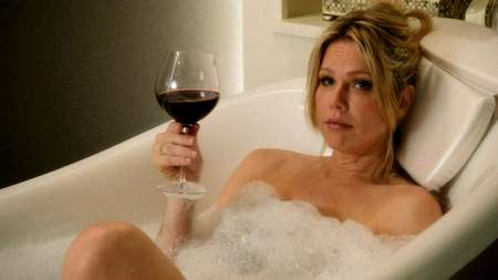 Andrea Roth as CAtherine  in bathtub with glass of wine